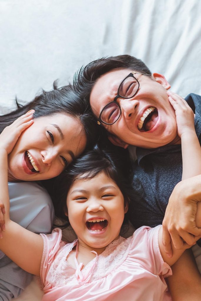 happy parents and young daughter