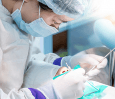 dentist treating a patient with implant-supported dentures