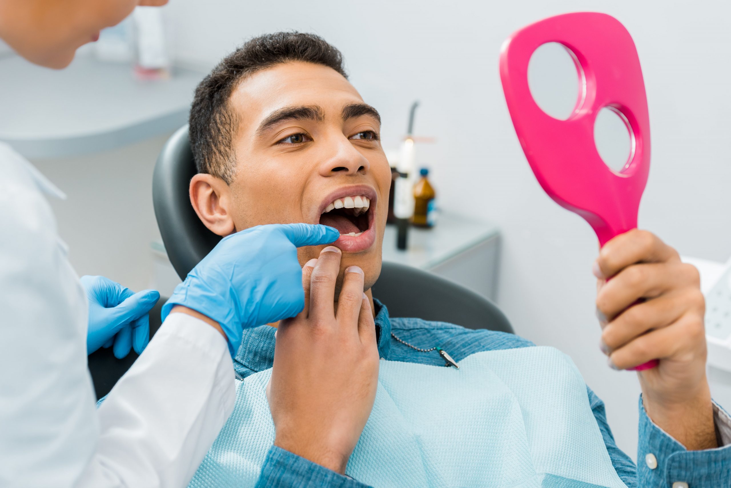 A man inspects his dental implants