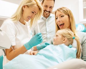 A family is getting their teeth checked using family dentistry services.