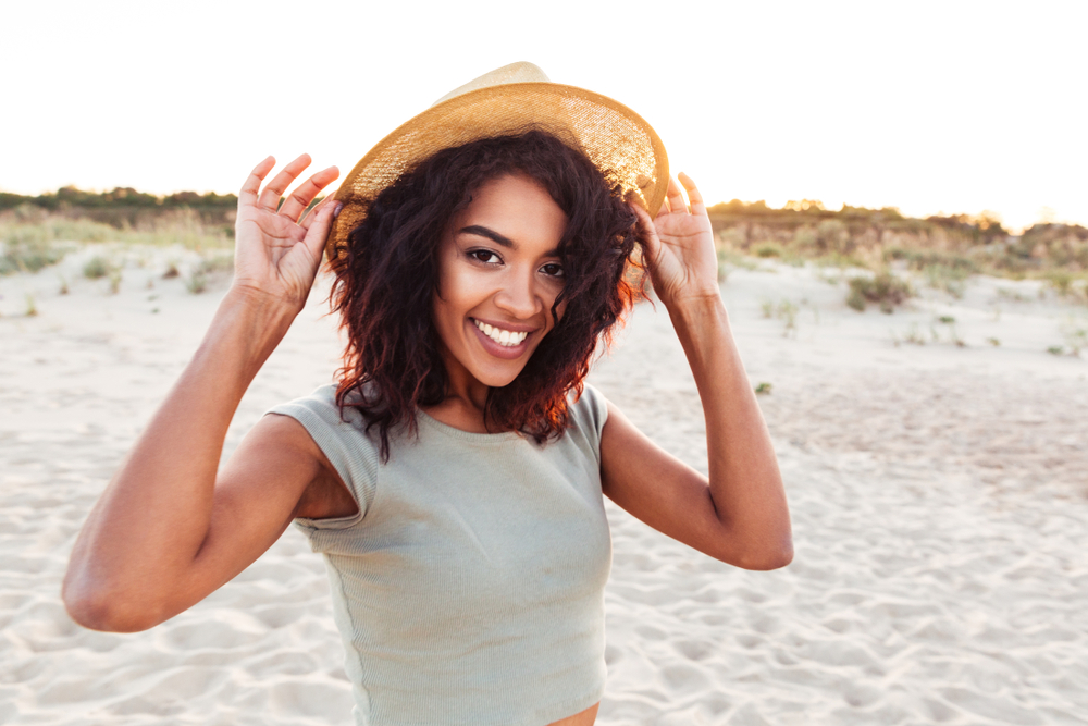 woman smiling after getting dental implants and teeth whitening