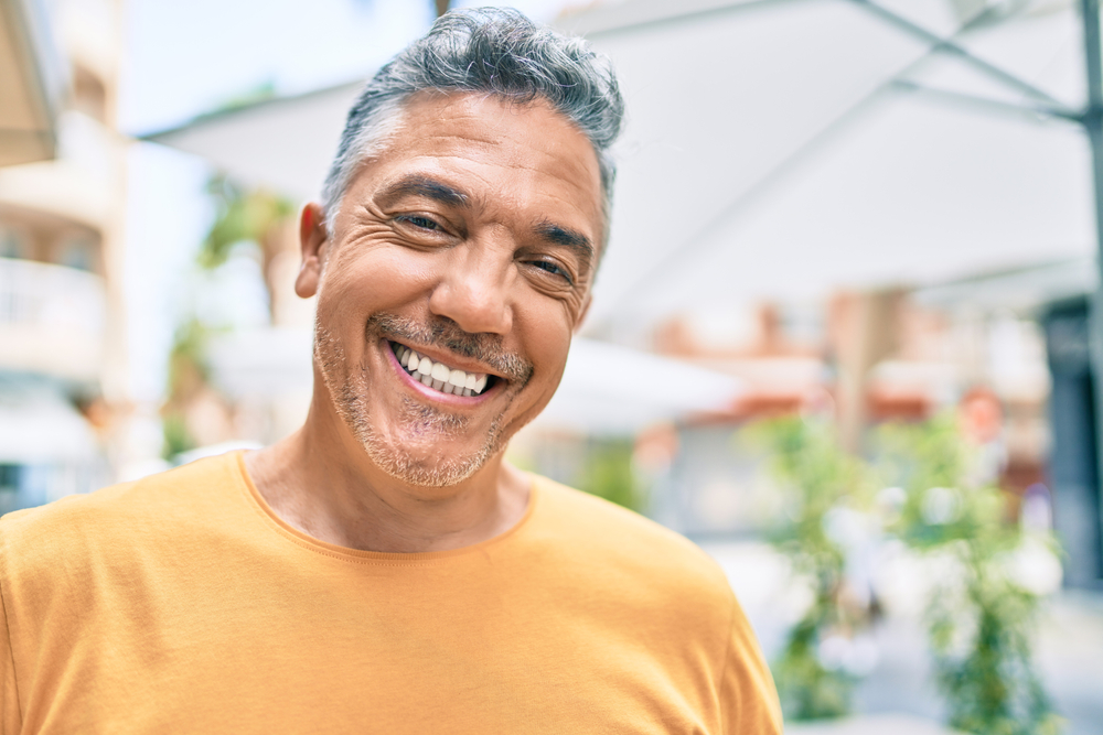 Man smiles after all-on-4 dental implants