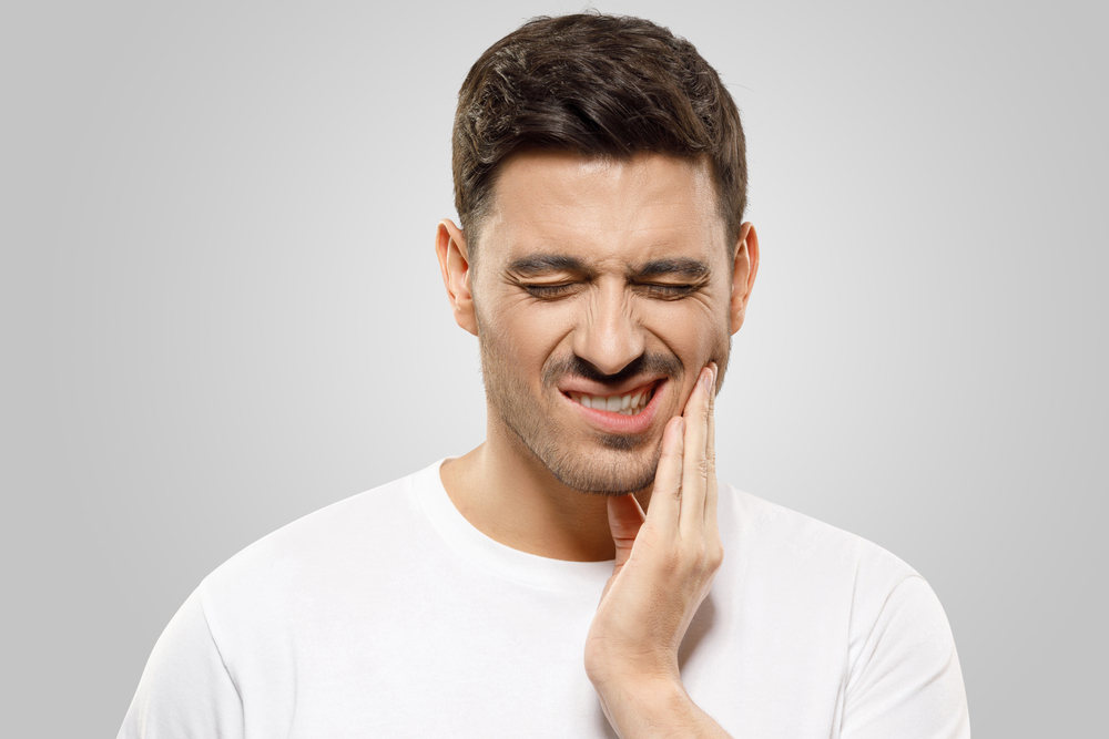 a man is experiencing pain before his root canal treatment