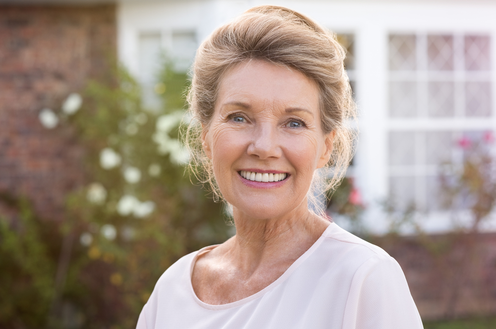 woman smiles after dental implants